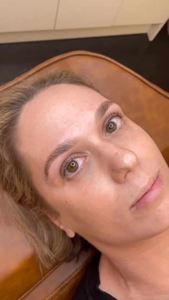 Client reclined with freshly shaped natural brows, flat daylight