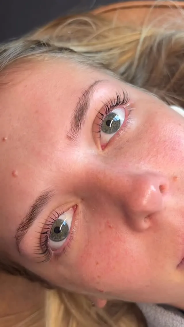 Blonde client with defined brows and lifted lashes, tilted to camera