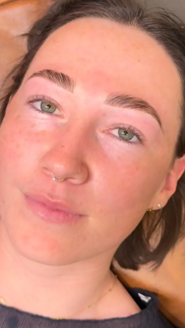 Client to camera with green eyes and softly laminated brows