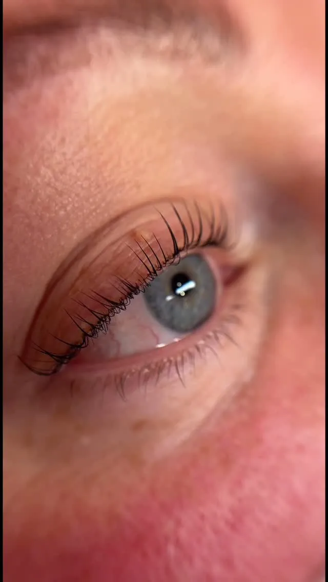 Soft-focus close-up of an eye with a dramatic Korean lash lift